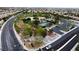 Aerial view of community park with tennis court, playground, green spaces, and ample parking in a residential area at 9052 Pine Mission Ave, Las Vegas, NV 89143