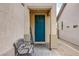 Home entrance featuring a charming walkway, a bench, and a blue front door for a welcoming appeal at 9052 Pine Mission Ave, Las Vegas, NV 89143
