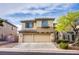 Attractive two-story home featuring a balcony, complemented by a two-car garage and manicured landscaping at 9052 Pine Mission Ave, Las Vegas, NV 89143