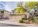 Inviting two-story home with a two-car garage, featuring well-kept landscaping and a charming exterior at 9052 Pine Mission Ave, Las Vegas, NV 89143