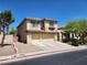 View of a two-story home with desert landscaping, including a two-car garage at 9052 Pine Mission Ave, Las Vegas, NV 89143
