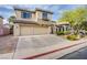 Charming two-story home with a spacious driveway and a two-car garage, complemented by a well-maintained front yard at 9052 Pine Mission Ave, Las Vegas, NV 89143