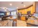 Updated kitchen with wood cabinets, stainless appliances, and a center island with granite counters at 9052 Pine Mission Ave, Las Vegas, NV 89143