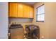 This laundry room features upper cabinets and newer washer and dryer units at 9052 Pine Mission Ave, Las Vegas, NV 89143