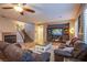 Inviting living room with wood flooring, fireplace, and ceiling fan at 9052 Pine Mission Ave, Las Vegas, NV 89143