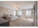Spacious main bedroom with plush carpeting, ceiling fan, and natural light from dual windows at 9052 Pine Mission Ave, Las Vegas, NV 89143