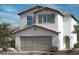 Two-story home featuring a neutral color scheme, a two-car garage and shuttered windows on the second story at 9540 Marsh Aster St, Las Vegas, NV 89139