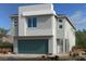 Modern two-story home with a gray exterior, a two-car garage, and professionally landscaped yard at 9997 River Corral St, Las Vegas, NV 89166