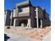 Modern two-story home featuring stucco exterior, open garage, and contemporary architectural details at 9997 River Corral St, Las Vegas, NV 89166