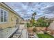 Back patio includes chairs and table with an upper view of the backyard at 10798 Muscari Way, Las Vegas, NV 89141
