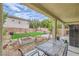 Enclosed backyard with patio, garden bed, and water feature at 10798 Muscari Way, Las Vegas, NV 89141