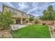 Well-maintained backyard with a grassy area, partial patio, seating and potential for landscaping at 10798 Muscari Way, Las Vegas, NV 89141