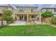 Spacious backyard featuring a covered patio, grass, and potential for outdoor entertaining and relaxation at 10798 Muscari Way, Las Vegas, NV 89141