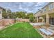 Well-maintained backyard with a fountain and lush green lawn at 10798 Muscari Way, Las Vegas, NV 89141
