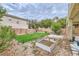 Landscaped backyard featuring a garden bed and stone fountain at 10798 Muscari Way, Las Vegas, NV 89141