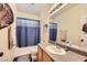 Well-maintained bathroom featuring a vanity with granite countertops and a shower-tub combo at 10798 Muscari Way, Las Vegas, NV 89141