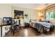 Comfortable bedroom featuring dark wood floors, and ample natural light from the window at 10798 Muscari Way, Las Vegas, NV 89141