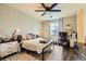 Cozy bedroom with a ceiling fan, window, and a dedicated workspace at 10798 Muscari Way, Las Vegas, NV 89141
