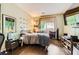 Inviting bedroom with dark wood flooring and a window providing natural light at 10798 Muscari Way, Las Vegas, NV 89141