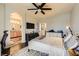 Bedroom with dark wood floors, ceiling fan, and a view into the Primary bathroom at 10798 Muscari Way, Las Vegas, NV 89141