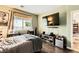 Bright bedroom with dark wood floors, a media area and plenty of space at 10798 Muscari Way, Las Vegas, NV 89141