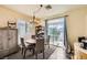 Charming dining area with sliding glass doors to balcony and modern light fixture at 10798 Muscari Way, Las Vegas, NV 89141