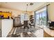 Bright dining area with sliding glass doors to balcony and stylish furnishings at 10798 Muscari Way, Las Vegas, NV 89141