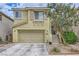 Charming two-story home with a two-car garage and well-maintained landscaping, offering curb appeal at 10798 Muscari Way, Las Vegas, NV 89141