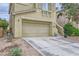 Charming two-story home with a two-car garage and low maintenance landscaping, perfect for desert living at 10798 Muscari Way, Las Vegas, NV 89141