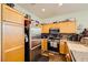 Efficient kitchen space with stainless steel refrigerator and plenty of cabinet storage at 10798 Muscari Way, Las Vegas, NV 89141