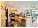 Well-equipped kitchen featuring light wood cabinetry and stainless steel appliances at 10798 Muscari Way, Las Vegas, NV 89141
