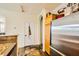 Kitchen area showcasing stainless steel refrigerator and convenient access to adjoining room at 10798 Muscari Way, Las Vegas, NV 89141
