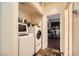 Functional laundry room with modern washer and dryer units at 10798 Muscari Way, Las Vegas, NV 89141