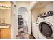 Convenient laundry area adjacent to bathroom and hallway at 10798 Muscari Way, Las Vegas, NV 89141