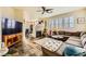 Bright living room with stone fireplace and dark tile flooring at 10798 Muscari Way, Las Vegas, NV 89141