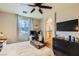 Spacious main bedroom with a TV and a view of the attached bathroom at 10798 Muscari Way, Las Vegas, NV 89141