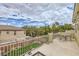 Enjoy outdoor dining on this large patio with iron railing overlooking the grassy backyard at 10798 Muscari Way, Las Vegas, NV 89141