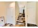 Unique staircase with stone-like tile and natural light filtering from the landing at 10798 Muscari Way, Las Vegas, NV 89141
