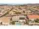 Aerial view of a neighborhood showcasing backyard pools and nearby desert landscape with scenic mountains at 1124 Whistle Ct, Henderson, NV 89011