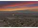 Expansive aerial view of a suburban community with mountain views against a scenic and colorful sky at 1124 Whistle Ct, Henderson, NV 89011
