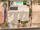 Overhead view of home with a sparkling pool, lush landscaping, and covered patio area at 1124 Whistle Ct, Henderson, NV 89011