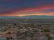 Panoramic aerial view of the neighborhood showcasing city lights and mountains at sunset at 1124 Whistle Ct, Henderson, NV 89011