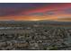 Wide aerial view of a community with a dramatic sky, highlighting mountain views and city proximity at 1124 Whistle Ct, Henderson, NV 89011