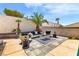 Outdoor patio area with desert landscaping, charming seating area, and vibrant accents creates a relaxing oasis at 1124 Whistle Ct, Henderson, NV 89011