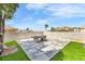 Paved patio with modern furniture offers a tranquil space for outdoor relaxation and entertaining at 1124 Whistle Ct, Henderson, NV 89011