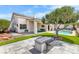 Backyard featuring a shimmering pool, covered patio, and an outdoor fireplace, blending relaxation and entertainment at 1124 Whistle Ct, Henderson, NV 89011
