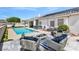 Backyard with a refreshing pool, soothing hot tub, and stylish patio seating, perfect for relaxation and entertainment at 1124 Whistle Ct, Henderson, NV 89011