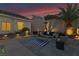 Cozy outdoor seating area with stylish furniture, complemented by manicured landscaping and serene lighting at 1124 Whistle Ct, Henderson, NV 89011