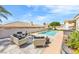 Backyard with a pristine pool, elegant patio furniture, and lush landscaping creates a serene outdoor retreat at 1124 Whistle Ct, Henderson, NV 89011
