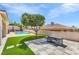 Landscaped backyard features a sparkling pool, manicured lawn, and cozy seating area for relaxation and entertainment at 1124 Whistle Ct, Henderson, NV 89011